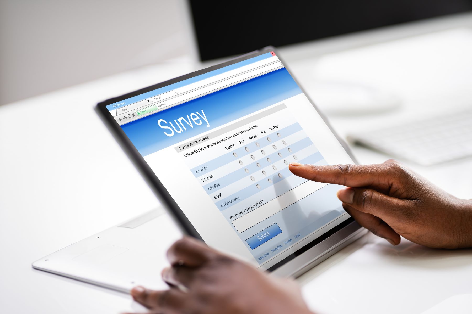 The picture shows a woman taking an online survey.