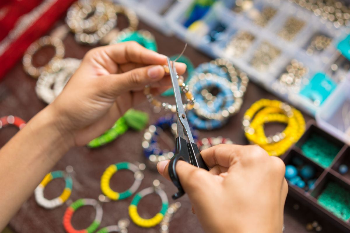 The photo shows a woman making handmade products.