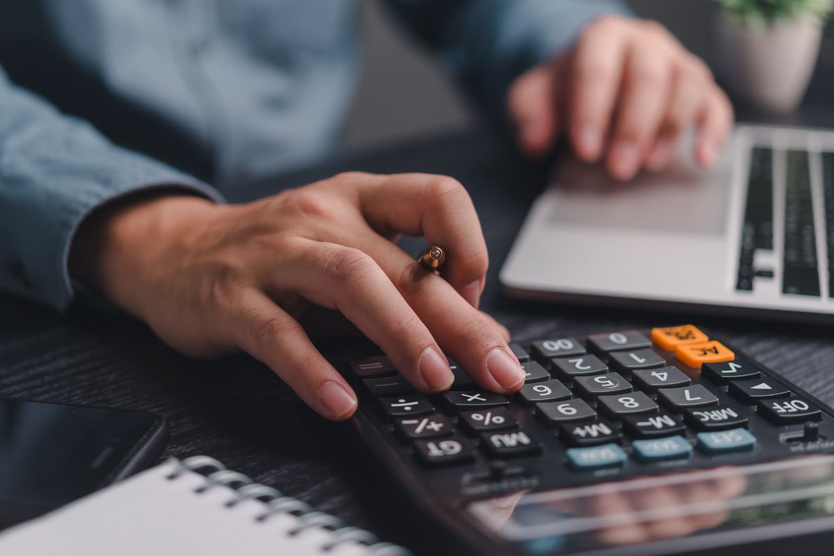 The photo shows a man budgeting.