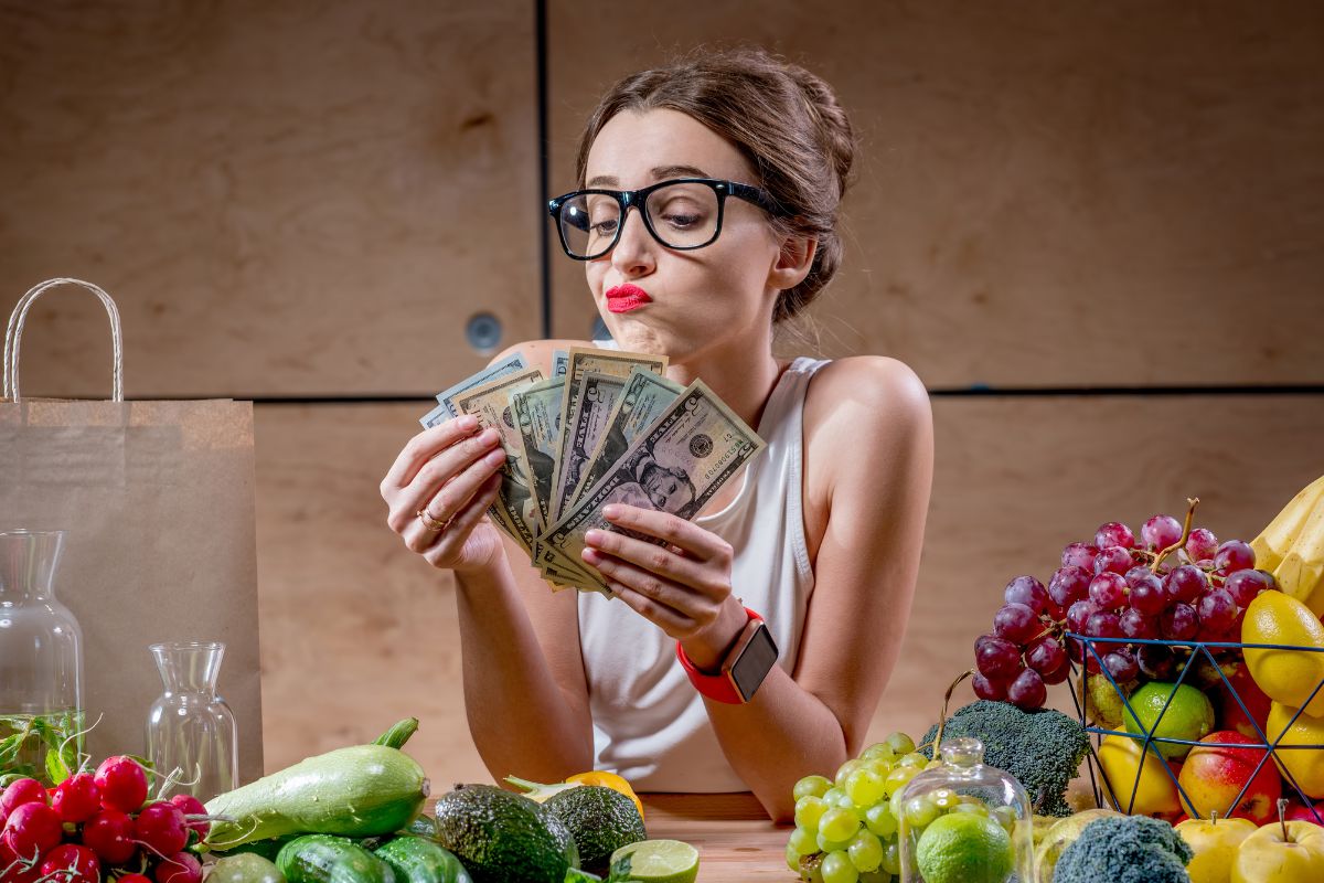 The image shows a girl counting money for food.