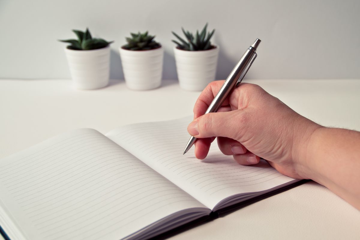 The picture shows a woman's handwriting in a notebook.