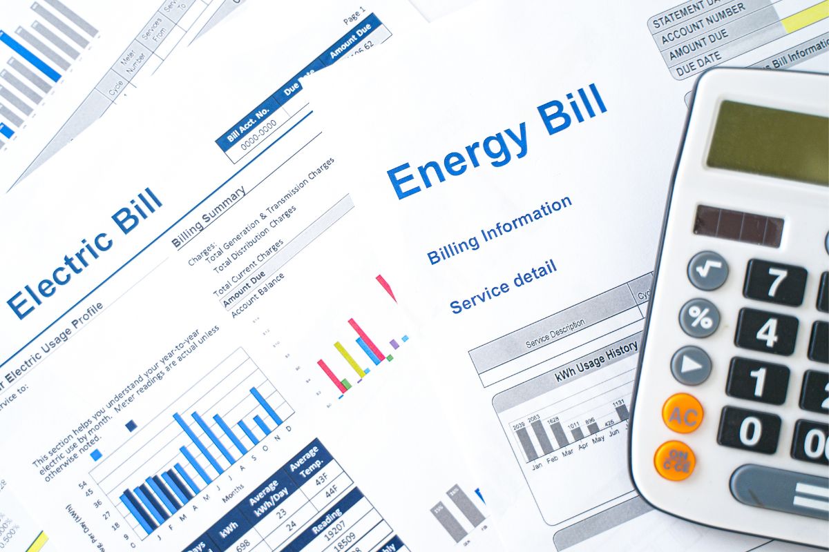 The image shows a calculator and a bill invoices.