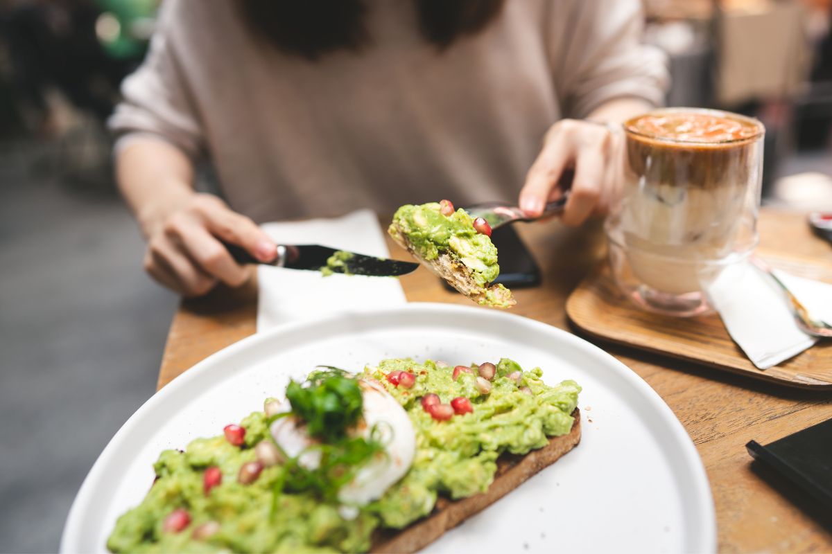 The photo shows a woman eating at the restaurant.