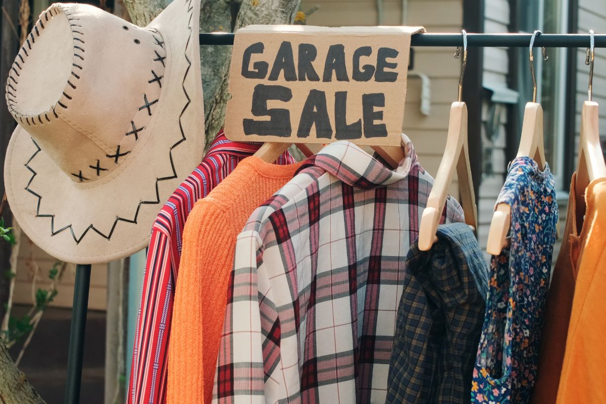 The image shows hung clothes, a hat, and a board with notes which means that selling unused items to declutter means more opportunities to save or invest.