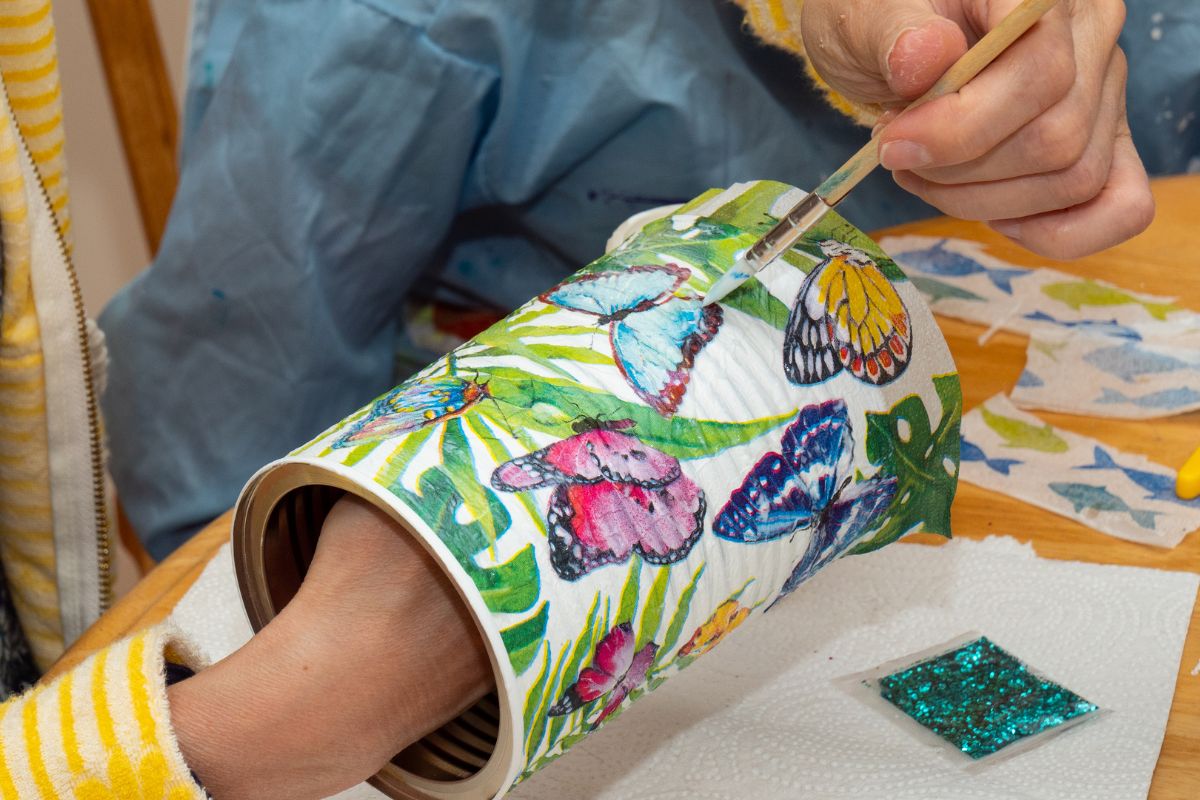 Picture of a woman painting a can.