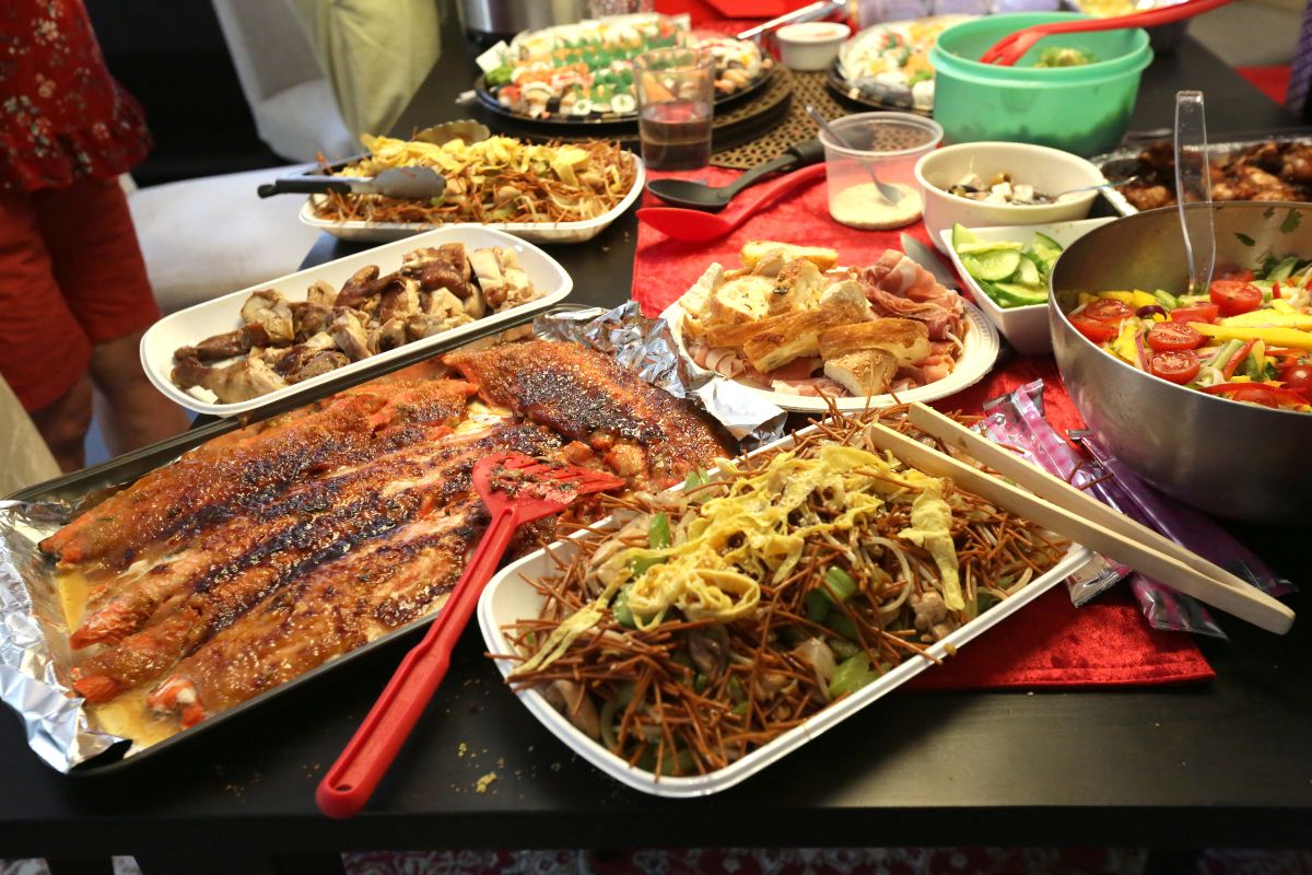 The image tells about food on the plates shared with one another referring to hosting a potluck with friends is an easy way to enjoy food and company while keeping costs low.