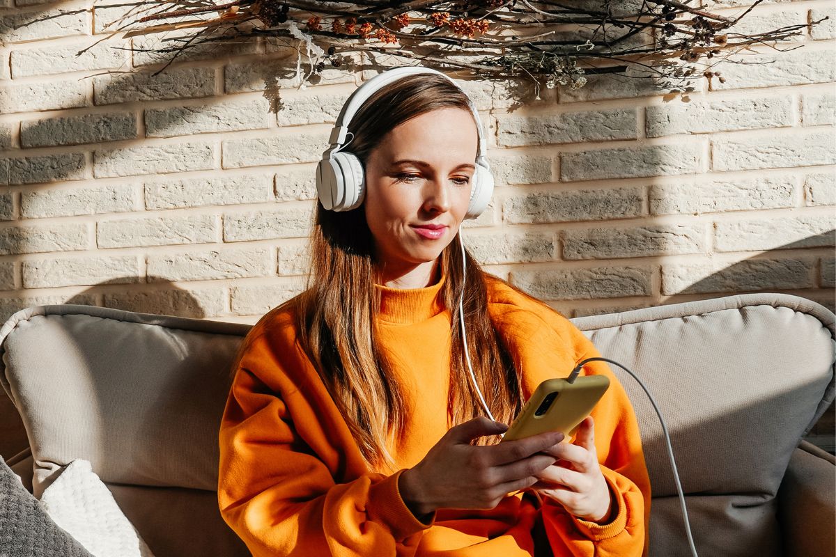 Photo of a woman listening to the podcast.