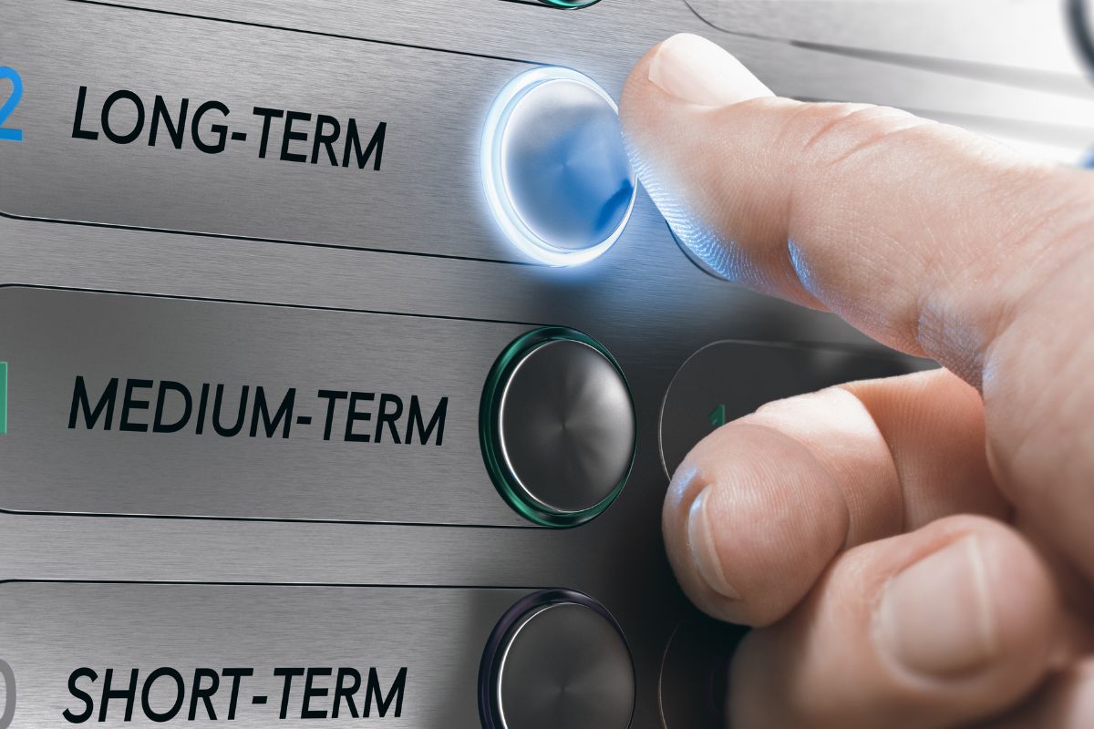 Picture of a man's hand pushing a long-term button.