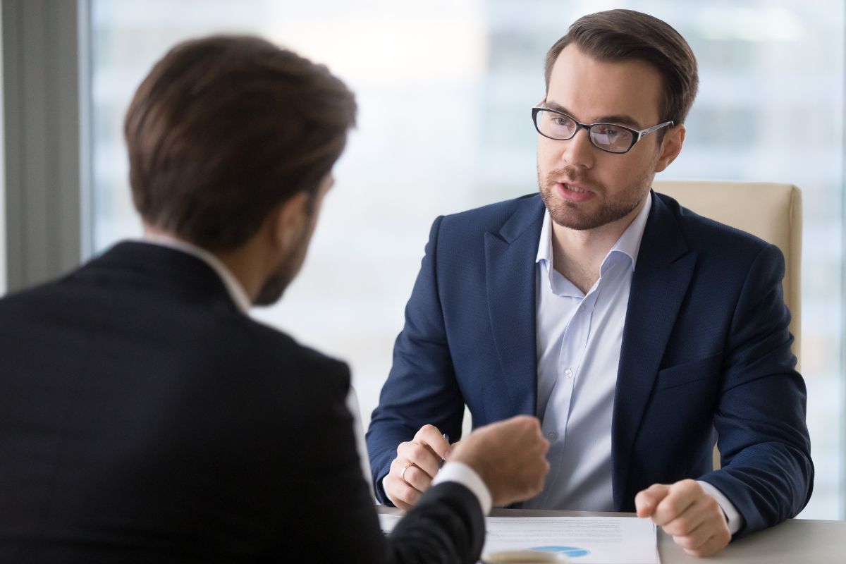 The picture shows two men talking to each other which means that learning the power of negotiation to make deals work in your favor is key to building wealth.