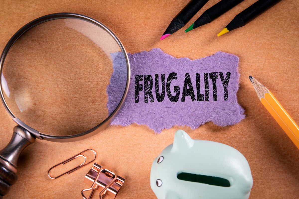 Picture of a paper with frugality wording and a piggy bank.
