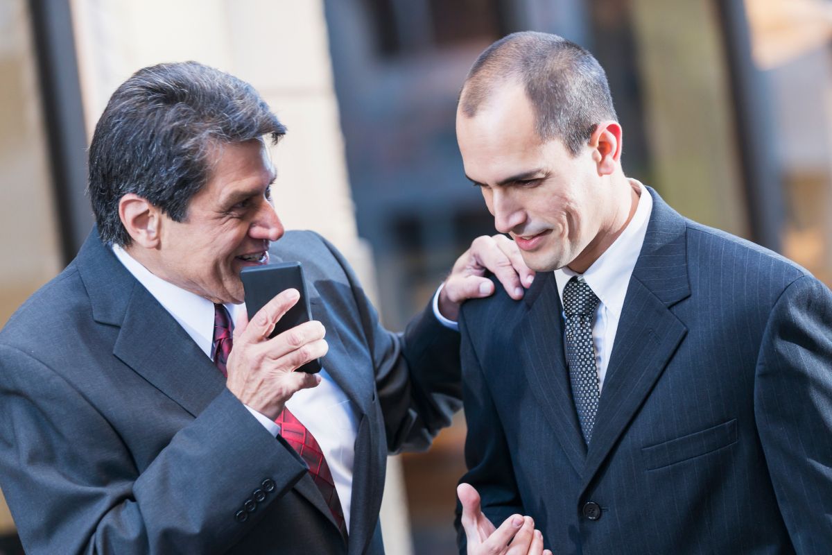 The photo shows men talking to each other.