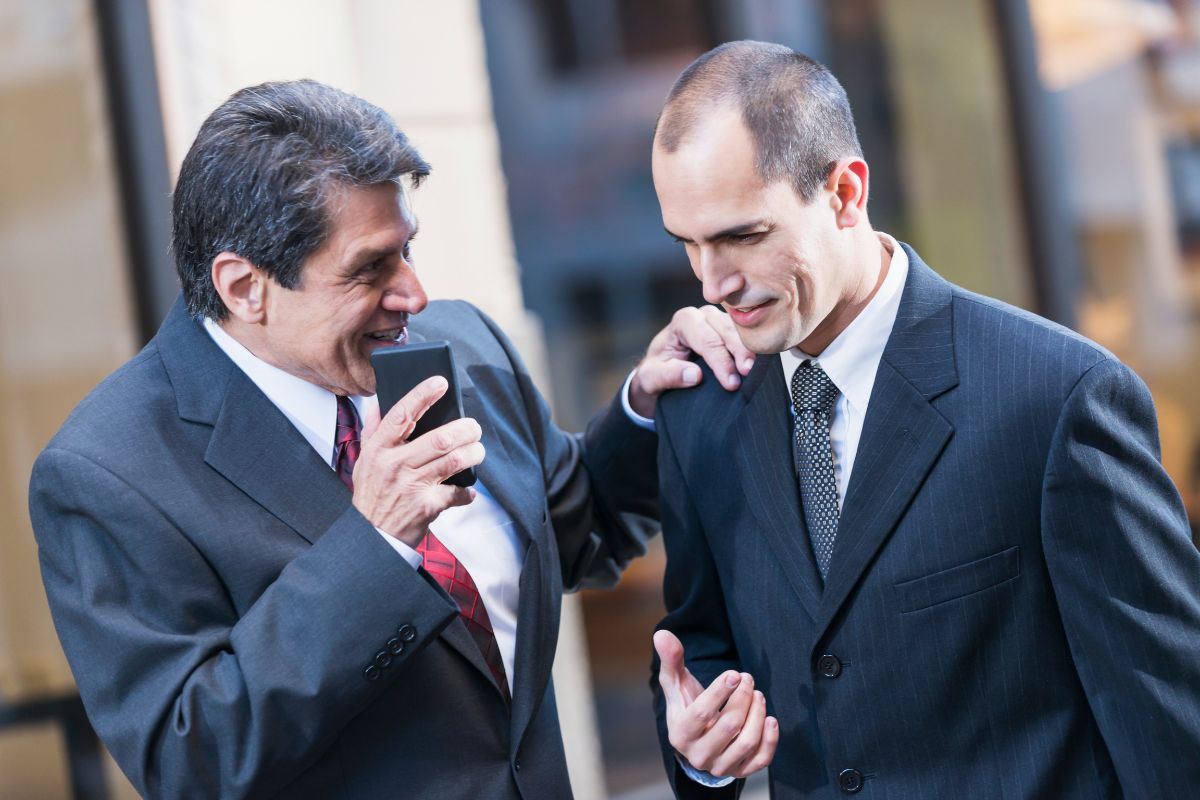 The image shows two men in suits talking together referring to building strong personal and business relationships that can help them grow.