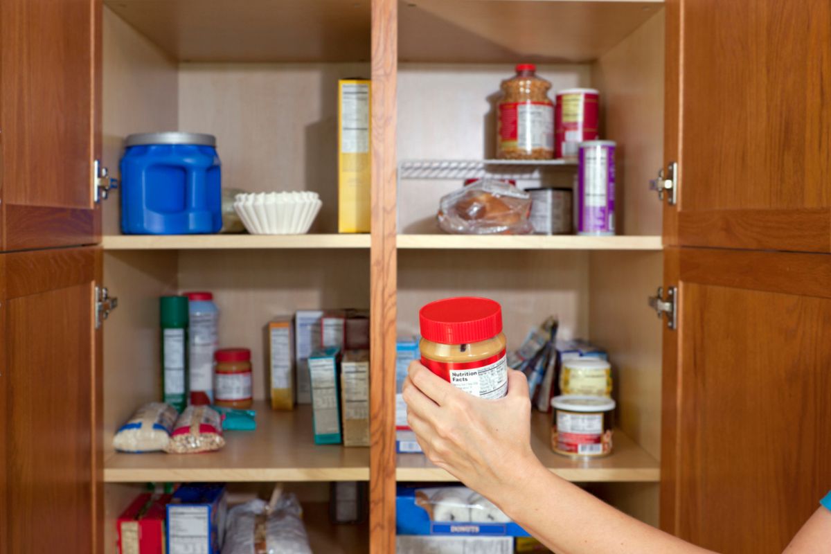 The image shows products on the corner and a girl hand-picking one which means repackaging and organizing pantry items helps prevent food from getting lost and going to waste.
