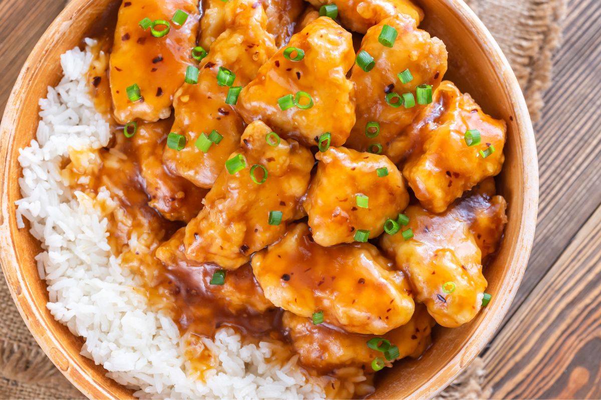 The picture shows a bowl with rice and chicken indicating that stretching meals with fillers like rice helps food last longer and keeps grocery spending down.