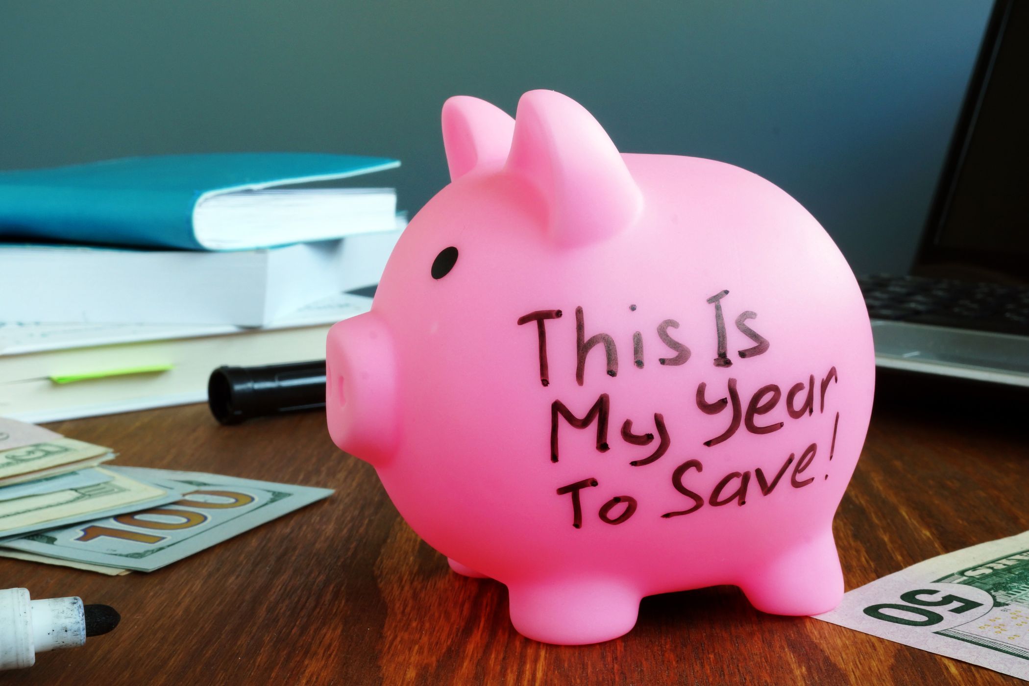 Image of a piggy bank with notes and money.