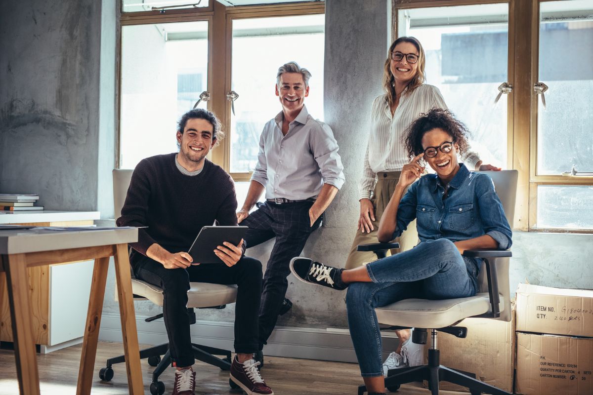 The photo is about boxes, a table, and a group of people altogether which refers to surrounding yourself with successful and ambitious people to learn from them and avoid negative and small-minded thinking.