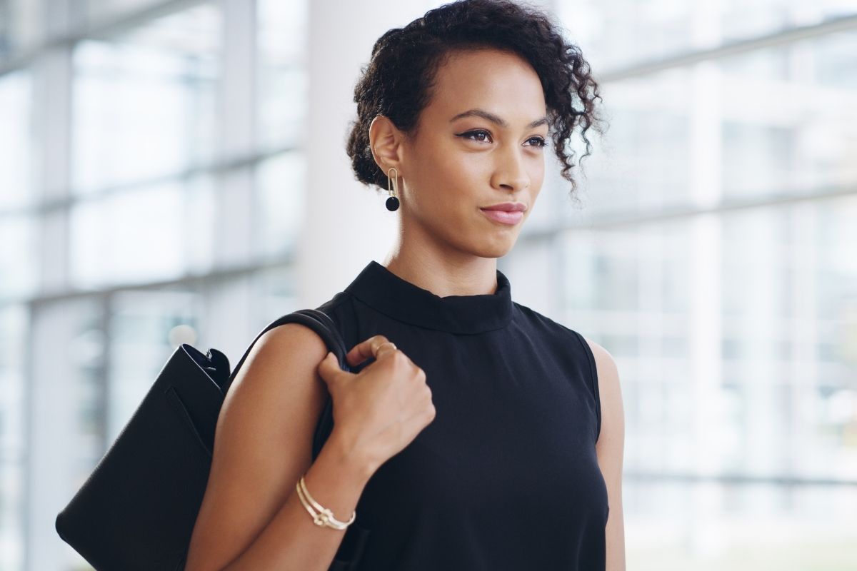 The photo tells about a girl walking with her bag on indicating to increase confidence to take financial risks and help you take steps toward higher earnings. 