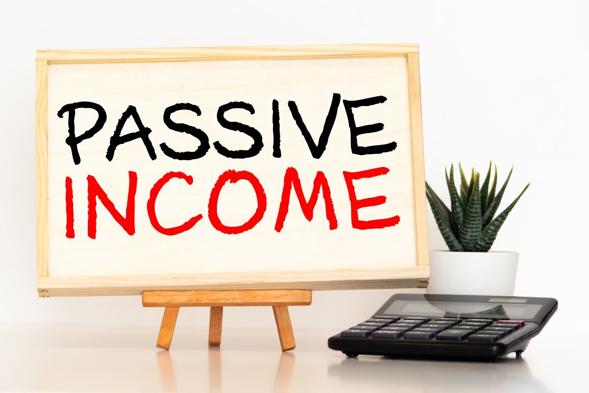 The photo tells about a plant, a calculator, and a board with notes referring to some skills that allow for passive income creation and can help you earn money even when you're not working.