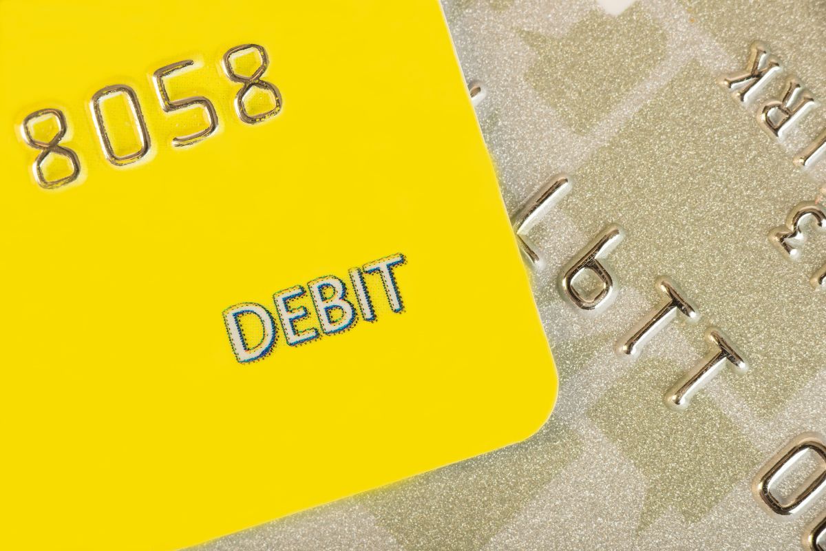 The picture shows cards with numbers and notes which means freezing your debit card can help you stick to your budget and save money faster.
