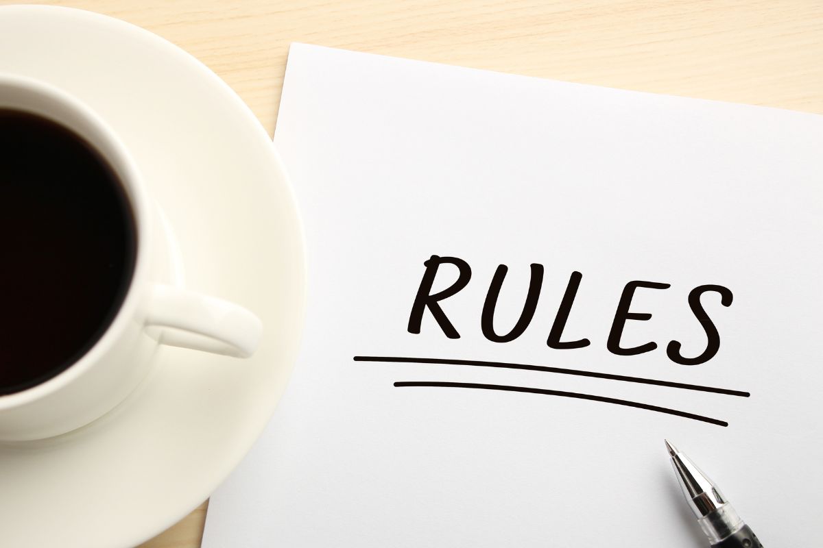 An image of a coffee and a paper with the rules written on it.
