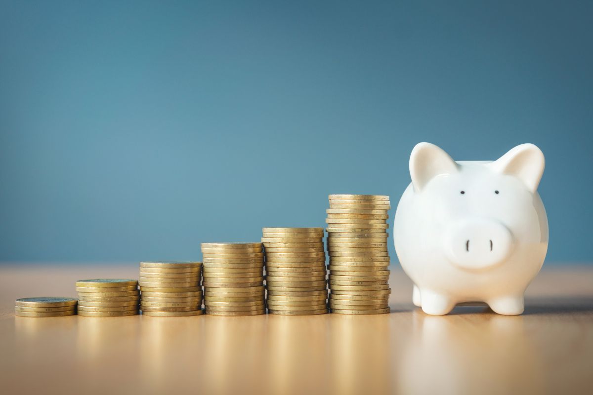 The photo shows coin stocks and a piggy bank which means gamify savings this makes saving money feel rewarding instead of restrictive.