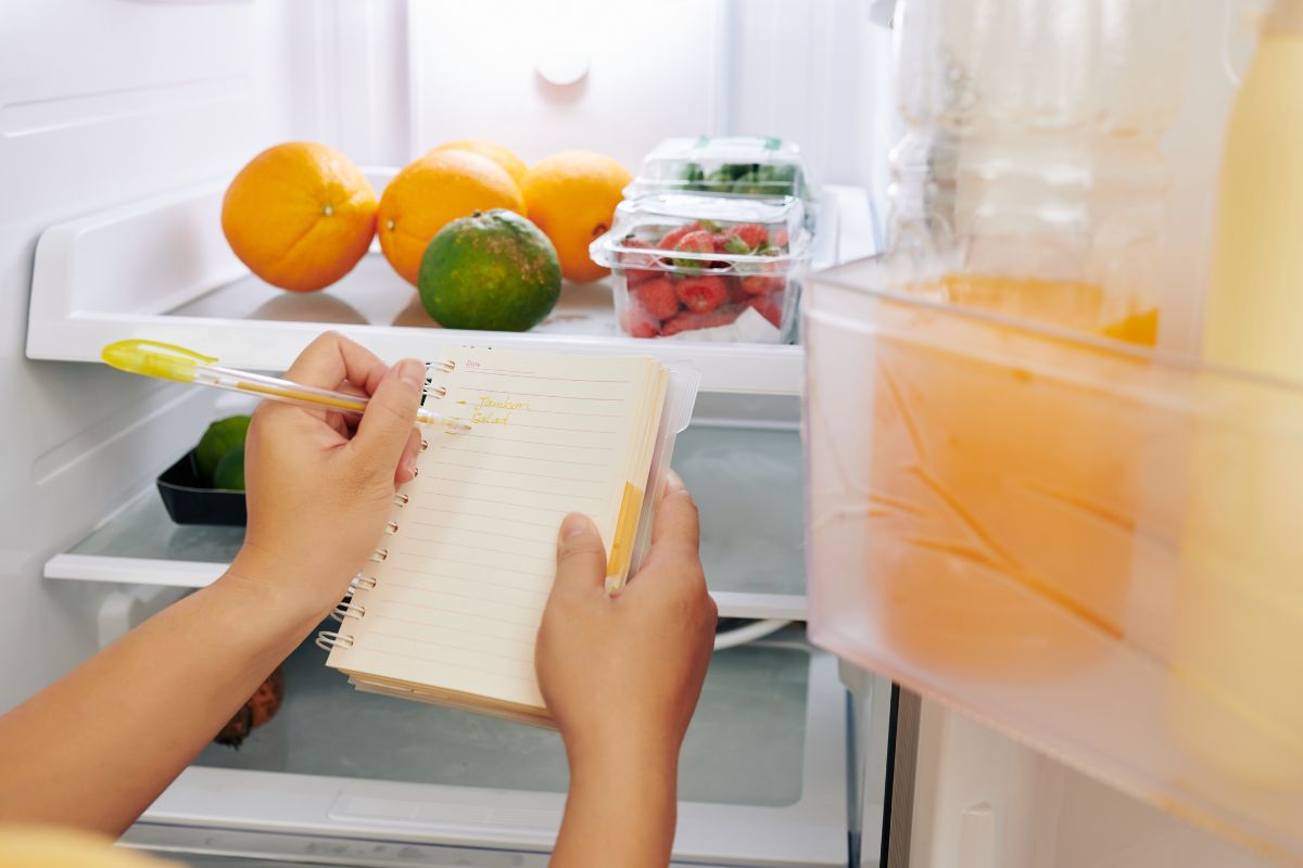 An image of a woman doing a food inventory.