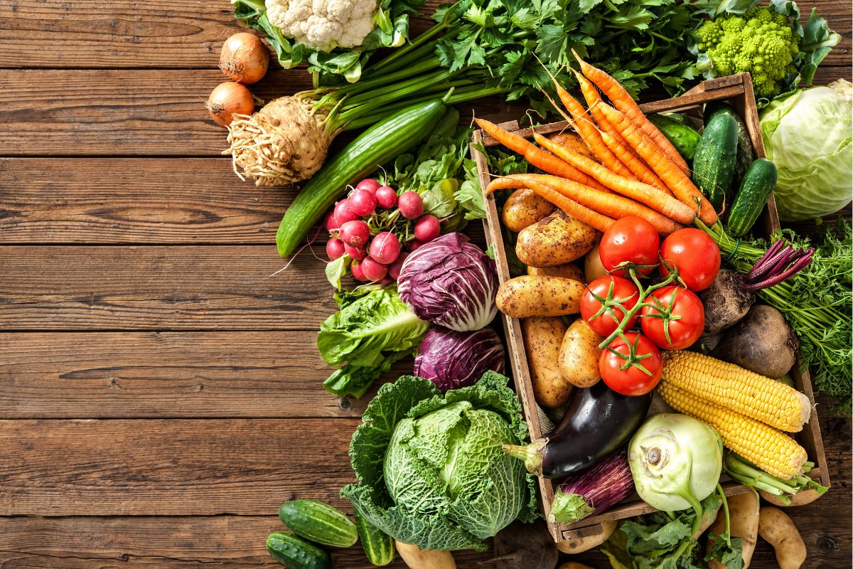 The photo tells about different kinds of vegetables on the table referring to reviving wilted veggies can go a long way in preventing waste.