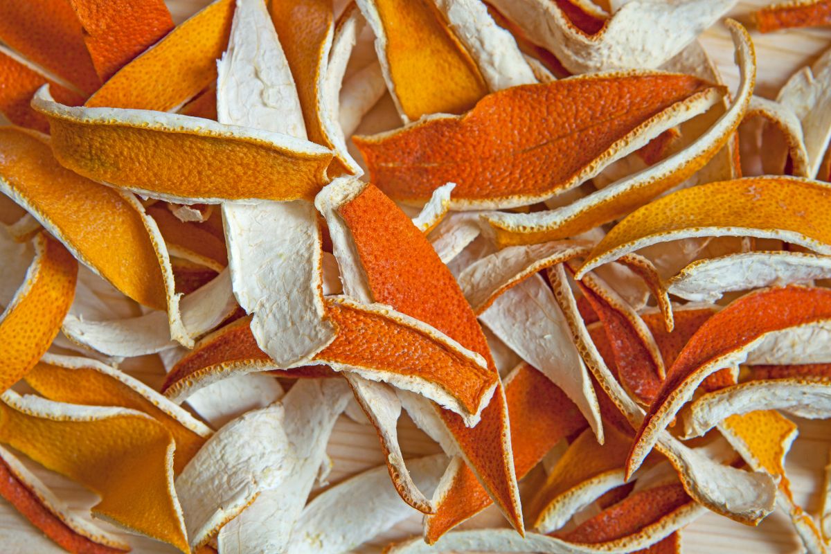 The photo shows peeled oranges indicating to use of citrus peels and scraps to make a smelling cleaning spray that can save money on store-bought cleaners and reduce food waste.