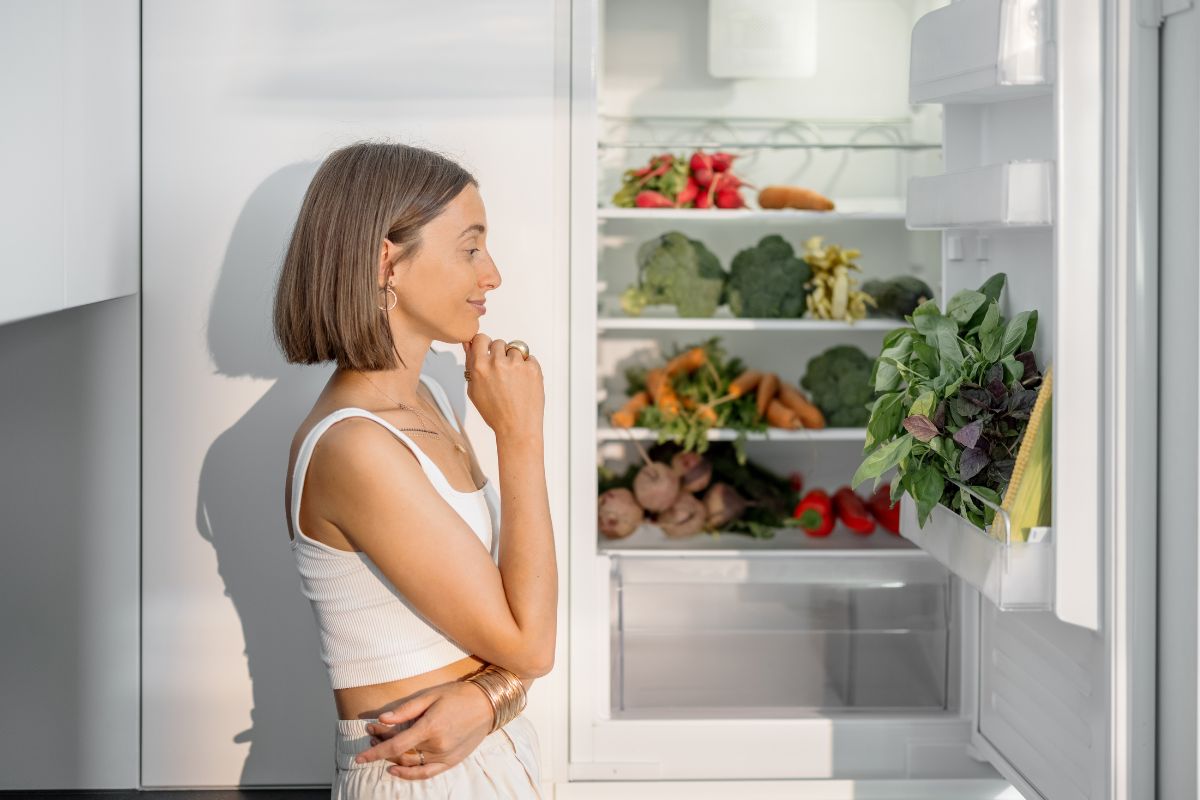 An image shows a woman planning meals.