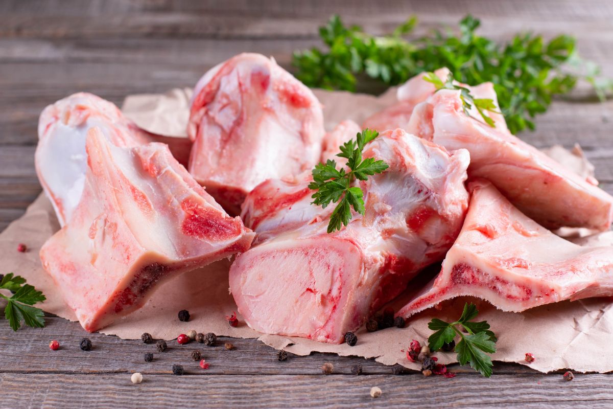The photo tells about meat bones with leaves which refers to turning bones and scraps into stock preventing waste and adding flavors to meals.
