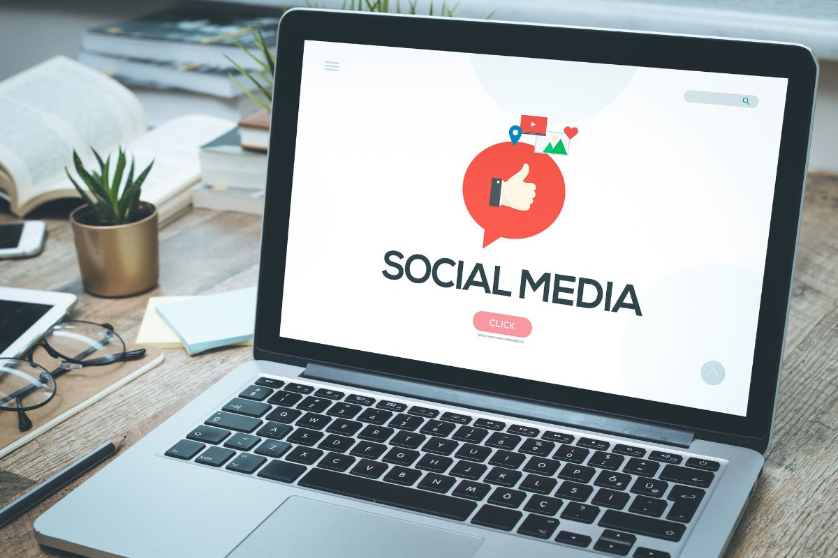 The photo shows a laptop with a social media display.