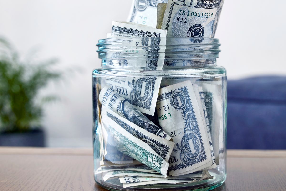 The picture shows a jar field with dollar bills referring to automate savings to make sure you stay on track.