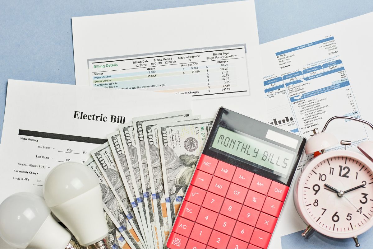 The image tells about a clock, bulbs, a calculator, and papers with notes which refers to negotiating bills means more money for savings.