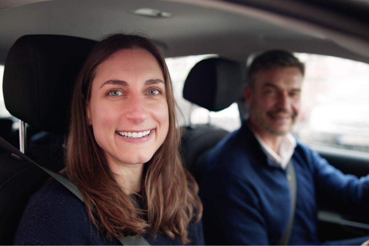 The image shows a driver and a passenger.