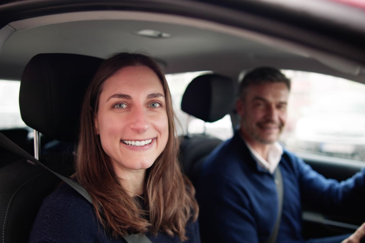 The pictures shows a driver and a passenger in a car referring to reduce transportation costs can save money each week and can go right into savings.