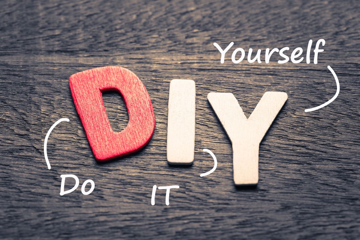 The image shows wooden letters with meaning indicating to DIY when possible to keep more money in your pocket.