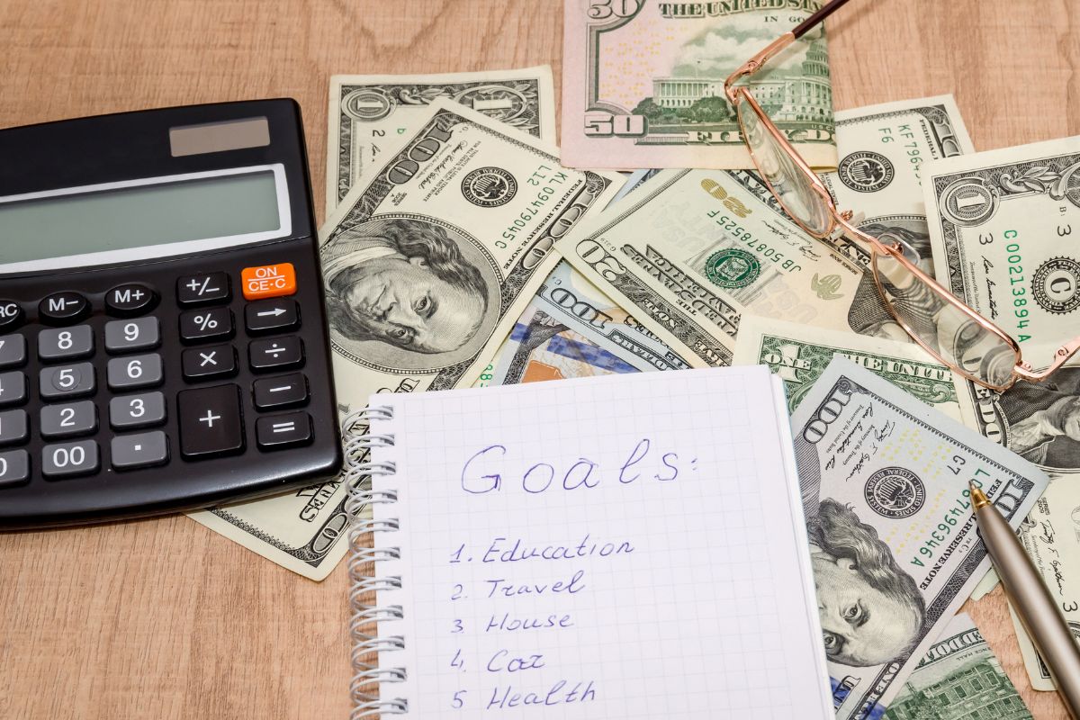 The photo of money and a notebook with a goal list.