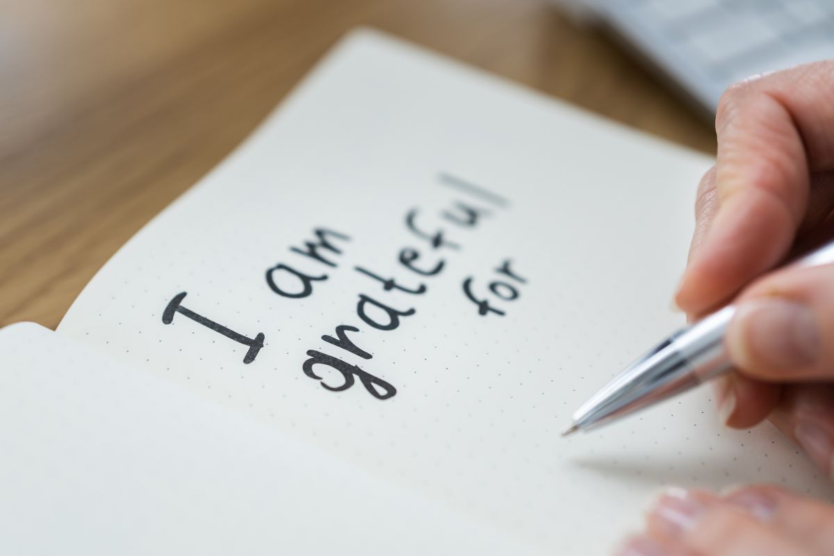 Image of a woman writing a gratitude letter.