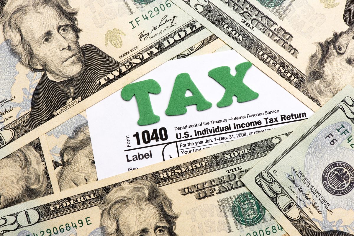 The image shows dollar bills and a piece of paper with notes referring to the use of tax advantages as one of the easiest ways to grow wealth.