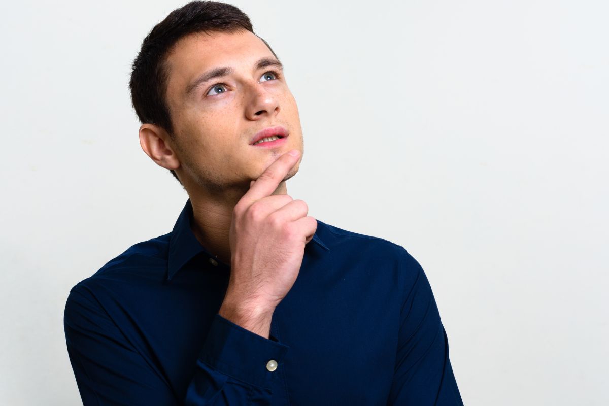The photo shows a man thinking.