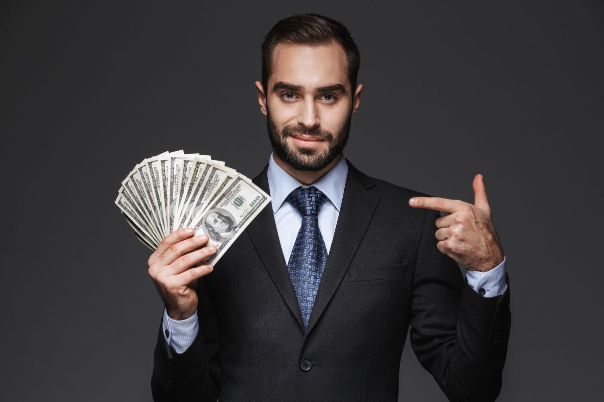 The picture of a man holding money.