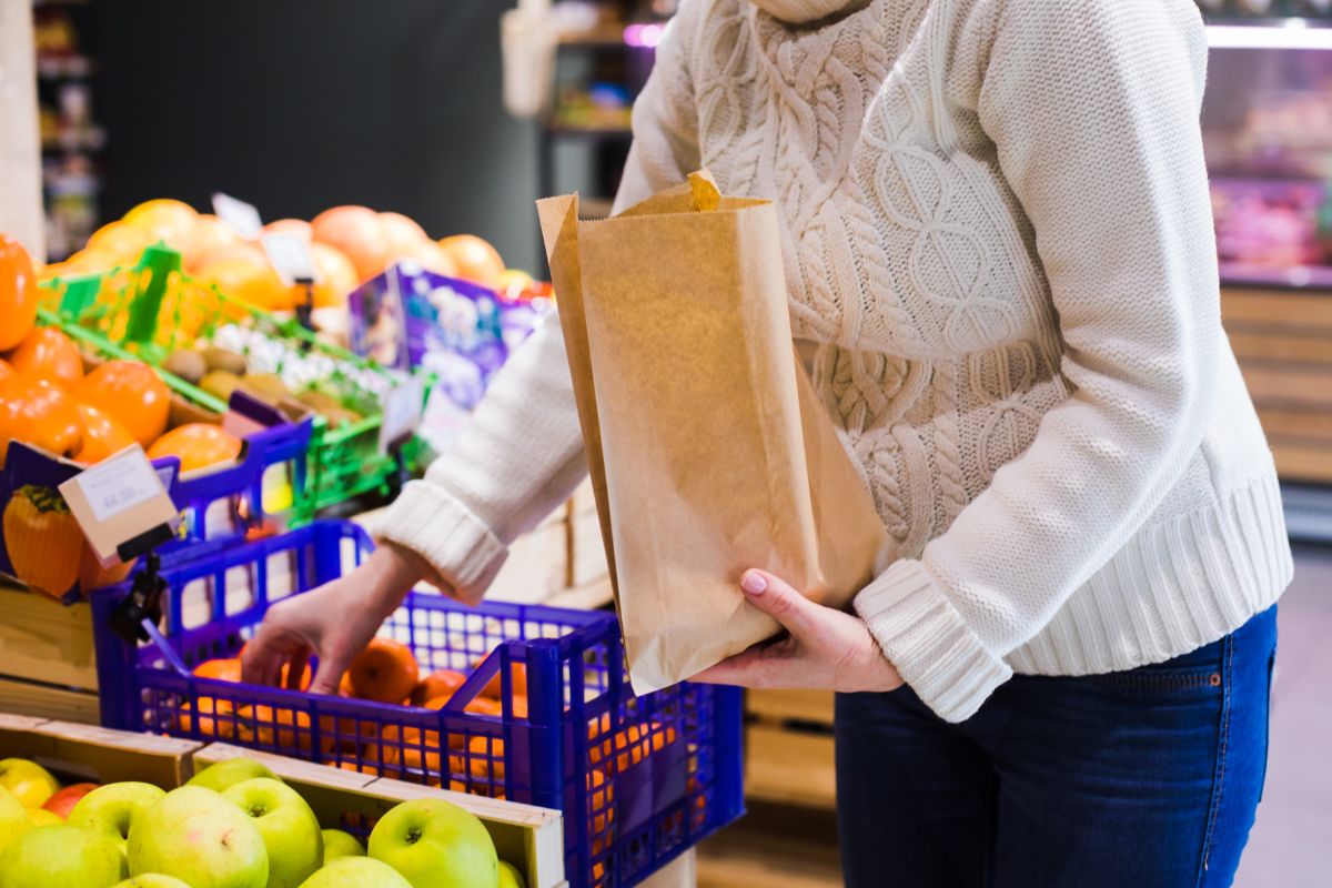 The photo shows a woman buying in bulk.