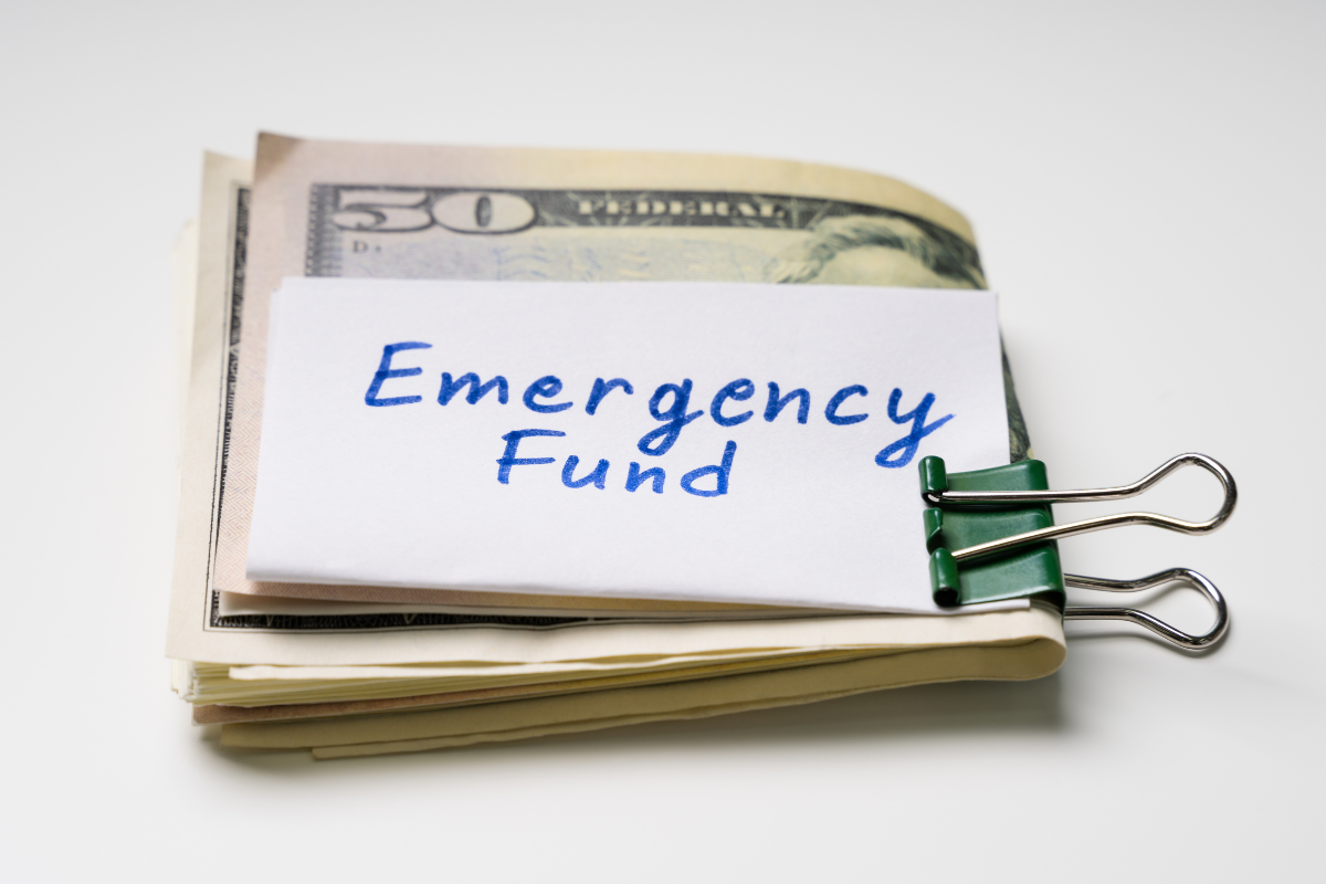 Picture of money and a paper with the emergency fund written.