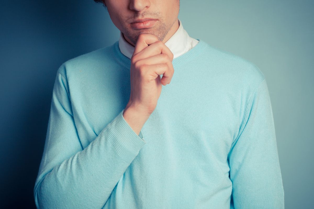 The image shows a man putting his hand on his chin indicating to think long-term build lasting wealth.
