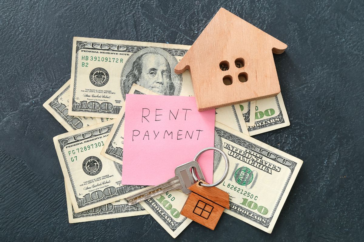 The image shows money and paper with rent payment wording.