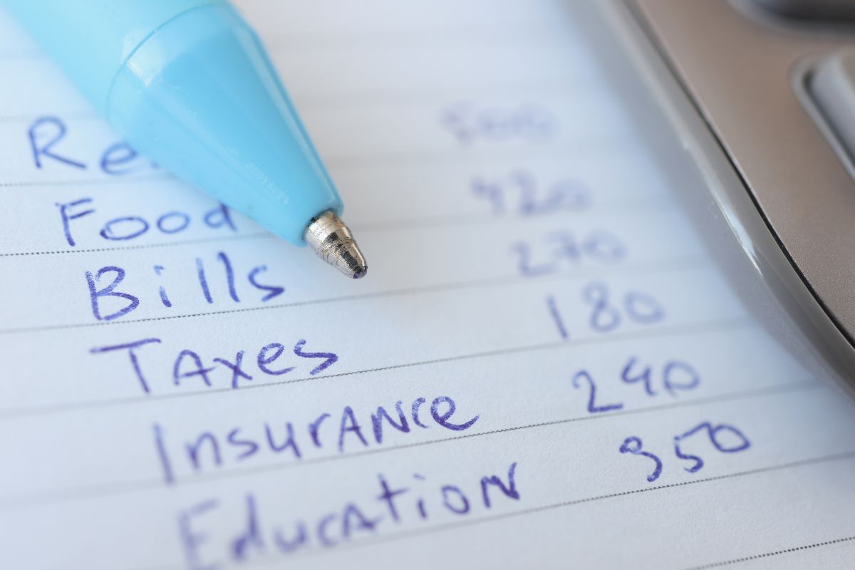 The picture of paper with a list of expenses.