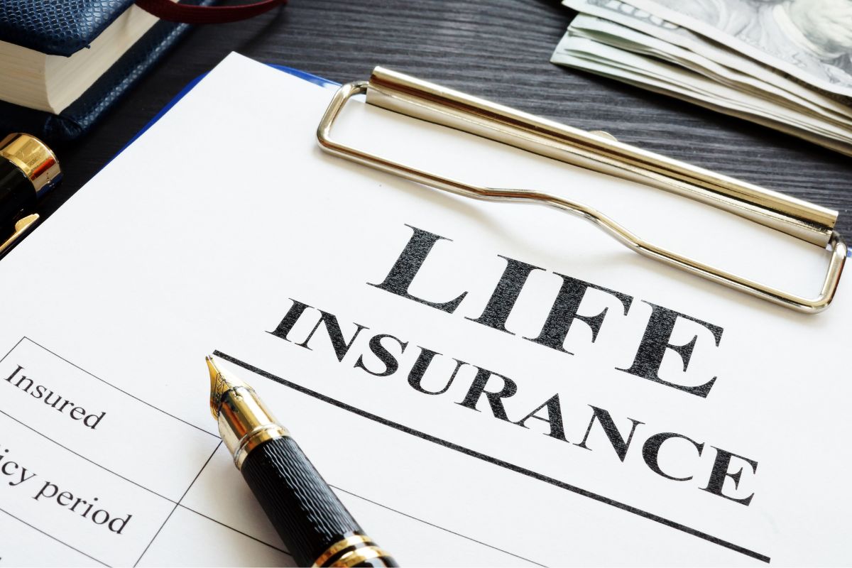 Picture of a pen and paper with a life insurance form.