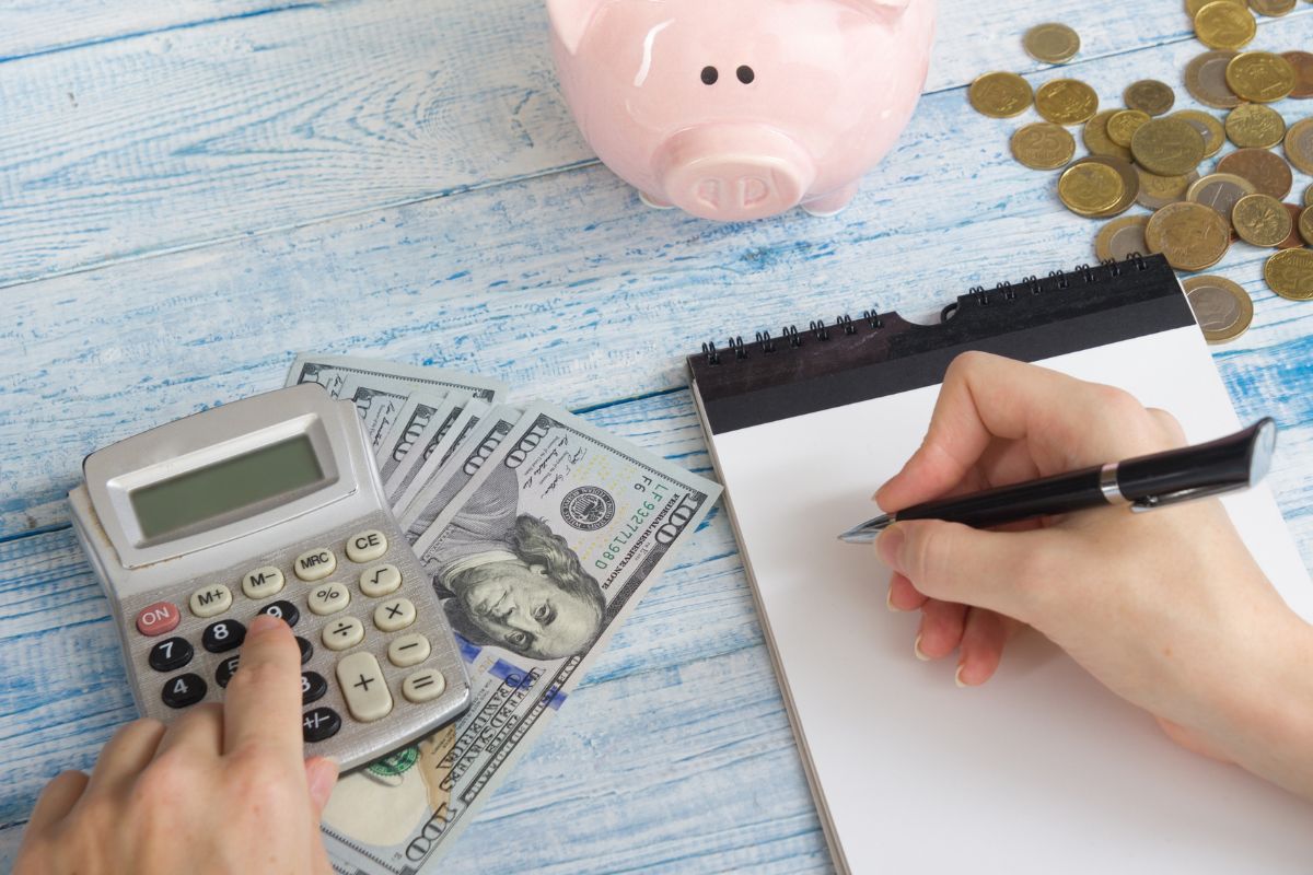The picture of a woman's hand budgeting money.