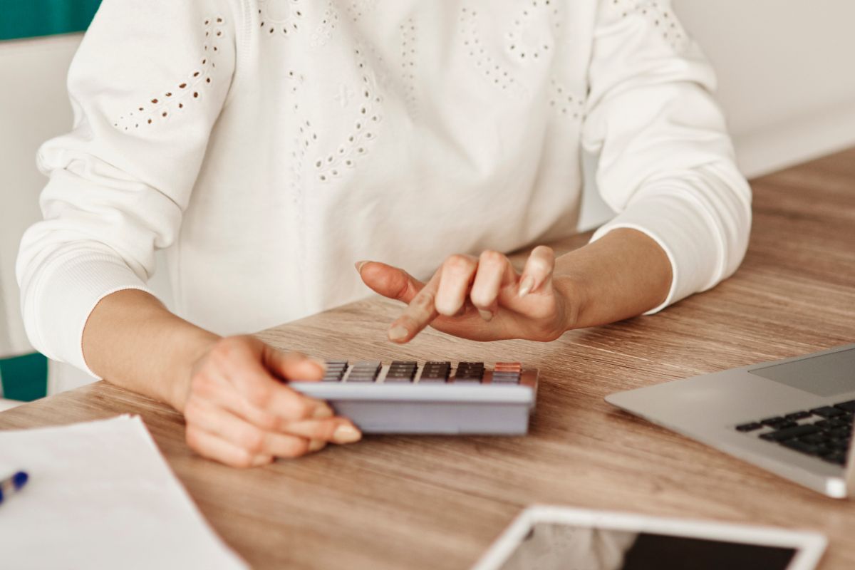 The image shows a woman adjusting her budget monthly.