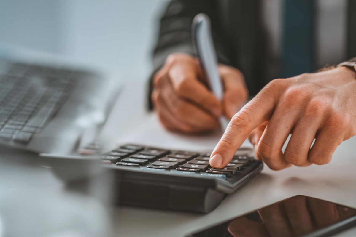 The picture of a man calculating his net worth.